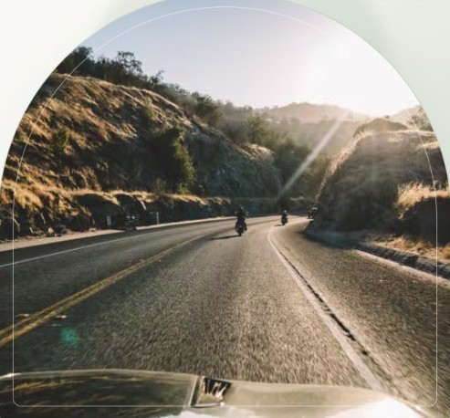 Riders on an open mountain road